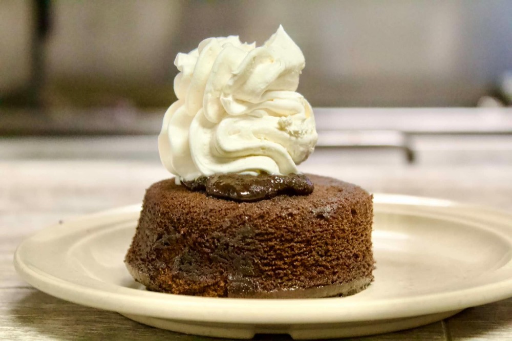 Chocolate lava cake topped with whipped cream