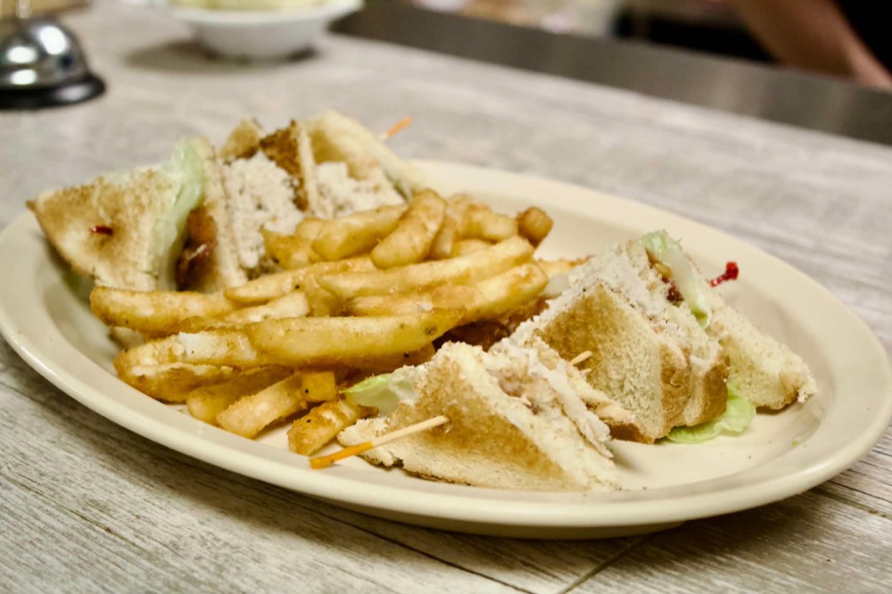 Club sandwich served with french fries