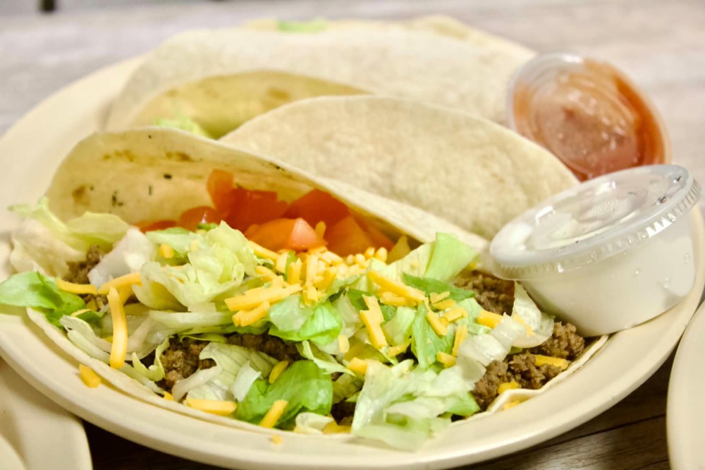 Seasoned beef tacos with lettuce, cheese and tomato